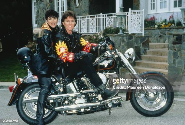 Athlete Bruce Jenner poses on a Harley-Davidson with his partner Kris Jenner, formerly Kris Kardashian, circa 1991.