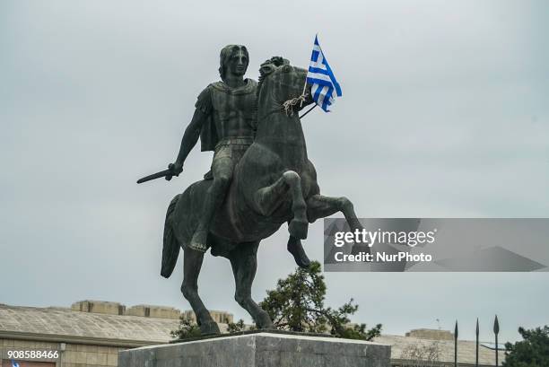 The statue of Alexander the Great holds a Greek flag during a protest rally against the developments on the issue between Athens and Skopje over the...