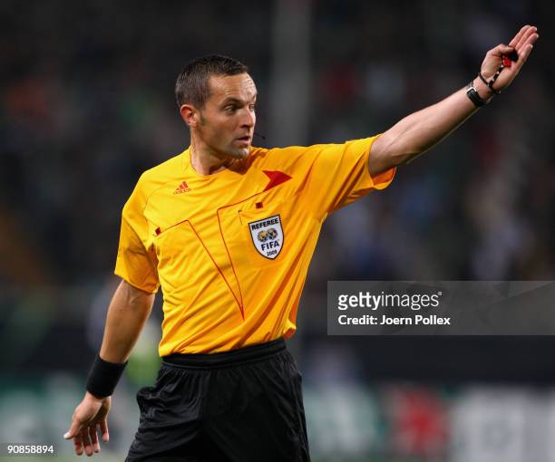 Referee Stephane Lannoy gestures during the UEFA Champions League Group B match between VfL Wolfsburg and CSKA Moscow at Volkswagen Arena on...