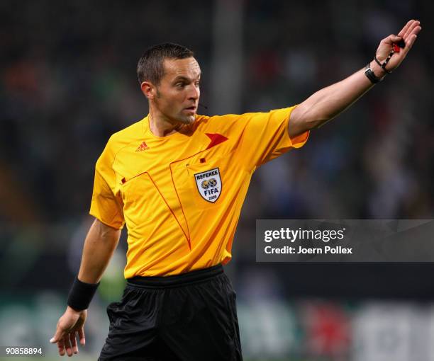 Referee Stephane Lannoy gestures during the UEFA Champions League Group B match between VfL Wolfsburg and CSKA Moscow at Volkswagen Arena on...