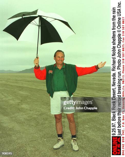 Black Rock Desert, Nevada. Richard Noble shelters from the rain before world land speed record was broken