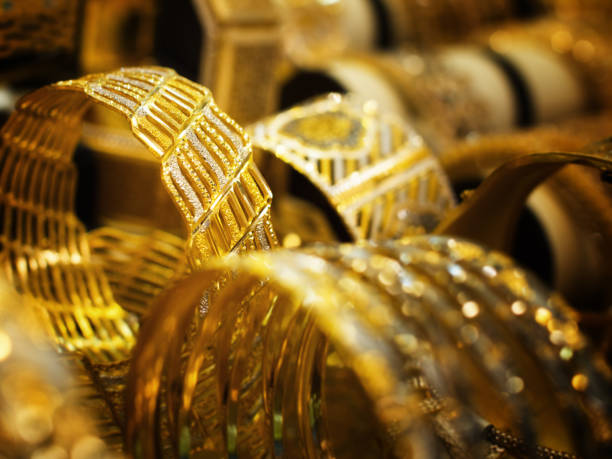 gold bracelets for sale at gold souk in dubai, united arab emirates - gold jewellery stock pictures, royalty-free photos & images