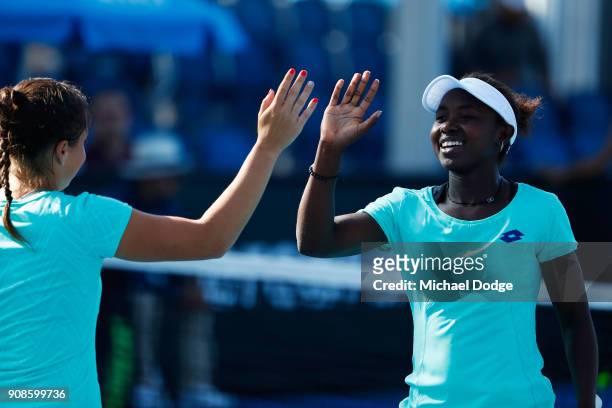 Elisabetta Cocciaretto of Italy and Sada Nahimana of Burundi celebrate winning a point in their girl's doubles match against Anri Nagata of Japan and...