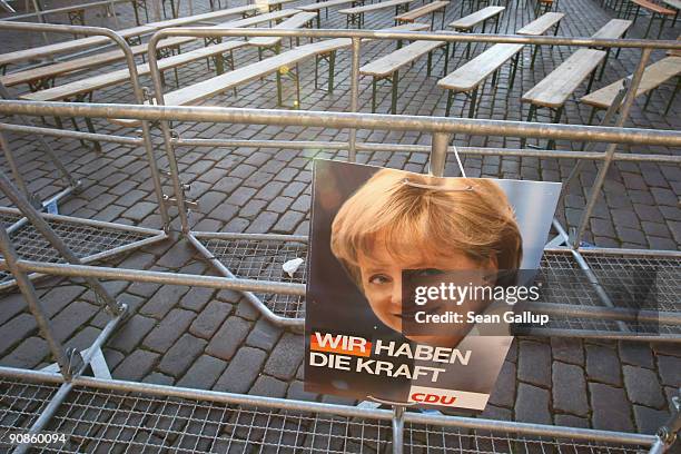 An election campaign poster featuring Chancellor and German Christian Democratic Union Chairwoman Angela Merkel hangs on a railing after an election...