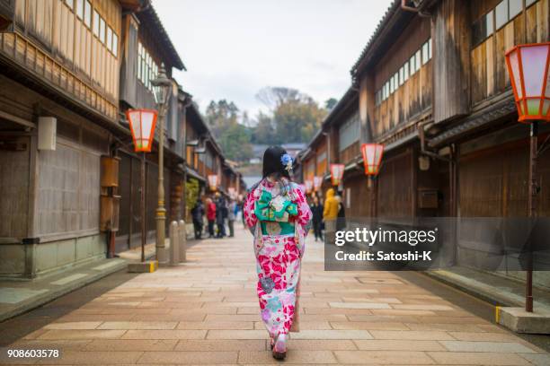 young woman in kimono walking in traditional japanese town - kanazawa stock pictures, royalty-free photos & images