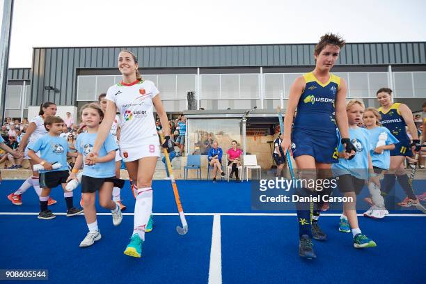 Maria Lopez of Spain and Kathryn Slattery of the Hockeyroos lead the teams onto the pitch during game five of the International Test match series...