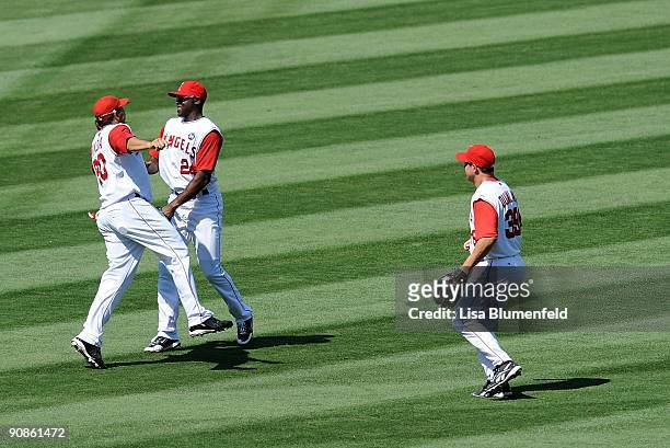 Juan Rivera and Gary Matthews Jr. #24 of the Los Angeles Angels of Anaheim celebrate defeating the Oakland Athletics 9-1 on August 30, 2009 in...