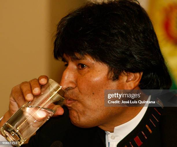 Bolivian President Evo Morales Ayma drinks water during a press conference at the 'Salon de los Espejos del Palacio de Gobierno' after returning from...