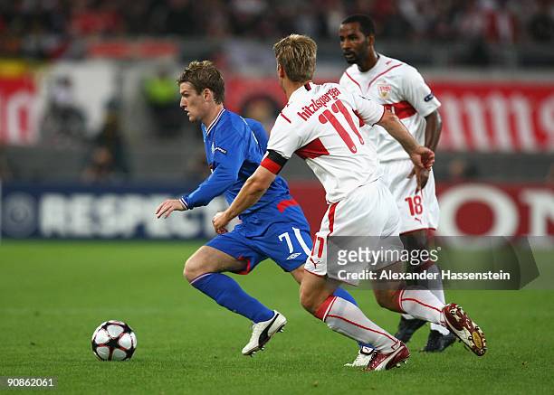 Steven Davis of Glasgow battles for the ball with Thomas Hitzlsperger of Stuttgart and his team mate Cacau during the UEFA Champions League Group G...