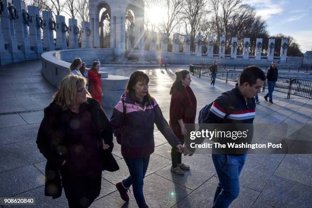 Visitors gather at the World War II Memorial on Saturday, January 20 in Washington, DC. The memorial is open during this federal government shutdown,...