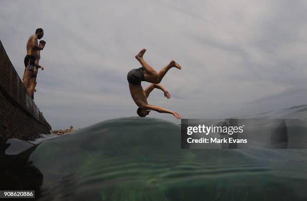 Boy dives into the ocean at Clovelly on January 22, 2018 in Sydney, Australia. Sydney's CBD reached a top of 33 degrees Celcius today, while...