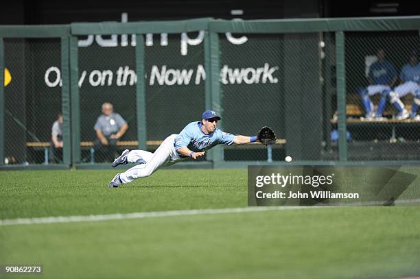 Right fielder Willie Bloomquist of the Kansas City Royals fields his position as he dives to catch a fly ball that fell in fair territory for a hit...