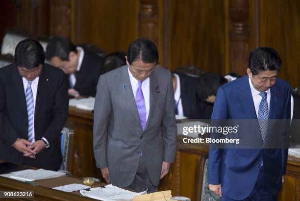 Shinzo Abe, Japan's prime minister, right, Taro Aso, Japan's deputy prime minister and finance minister, center, and Toshimitsu Motegi, Japan's...