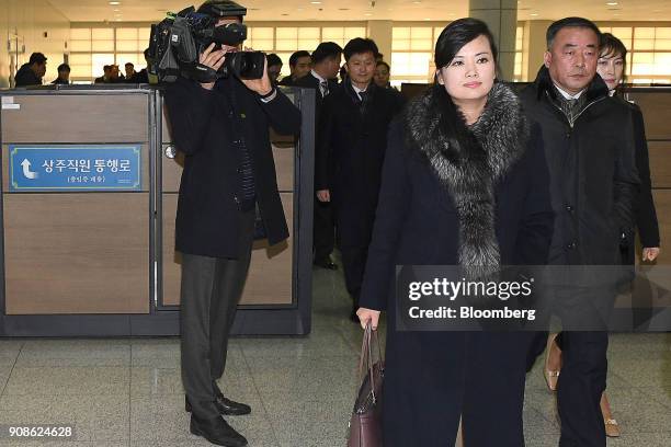 Hyon Song Wol, a North Korean pop star, party member and head of an advance team for North Koreas art troupe, center right, walks through the...