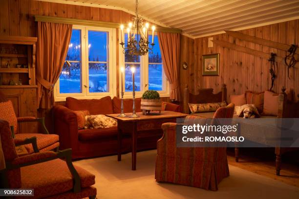 cozy mountain cabin interior with candlelight, oppland county norway - log cabin stock pictures, royalty-free photos & images