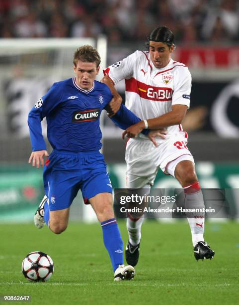 Sami Khedira of Stuttgart battles for the ball with Steven Davis of Glasgow during the UEFA Champions League Group G match between VfB Stuttgart and...