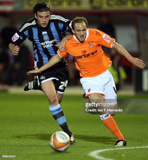 Andy Carroll chases David Vaughan during the Coca-Cola League Championship match between Blackpool and Newcastle United at Bloomfield Road Stadium on...