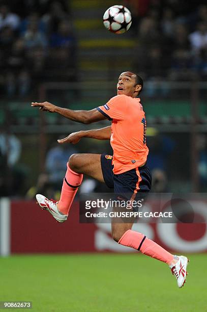 Barcelona's French forward Thierry Henry jumps for the ball during his team's UEFA Champions League football match against Inter Milan at San Siro...