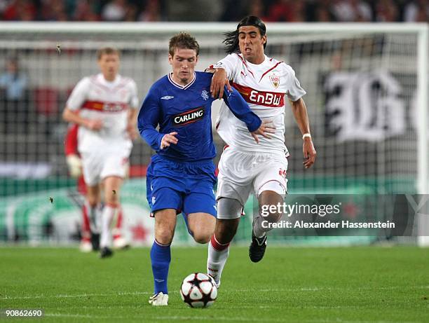 Sami Khedira of Stuttgart challenges Steven Davis of Glasgow during the UEFA Champions League Group G match between VfB Stuttgart and Rangers FC on...