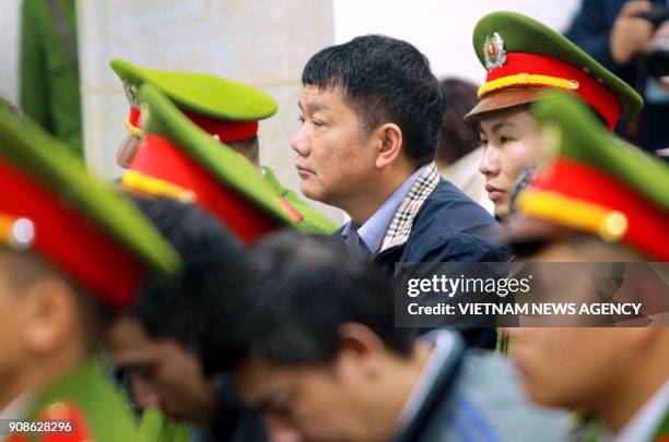 Former politburo member and former chairman of Vietnam's national oil company PetroVietnam, Dinh La Thang , listens along with other defendants at...