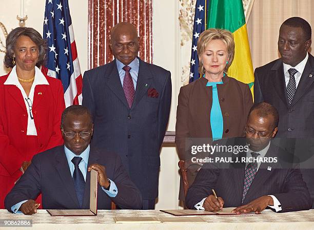 Looking on from the rear row are US Ambassador to Senegal Marcia Bernicat, Senegalese President Abdoulaye Wade, US Secretary of State Hillary Rodham...