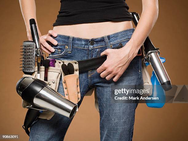 mid section view of hairdresser with tool belt - hair curlers stock pictures, royalty-free photos & images