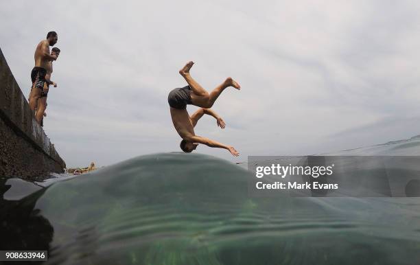 Boy dives into the ocean at Clovelly on January 22, 2018 in Sydney, Australia. Sydney's CBD reached a top of 33 degrees Celcius today, while...