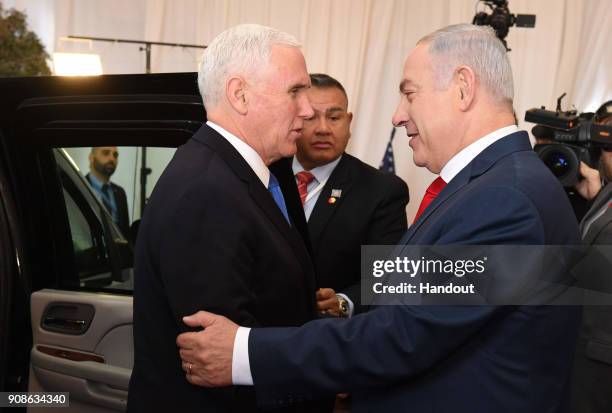 In this handout photo provided by the Israel Government Press Office , US vice President Mike Pence is greeted by Israeli Prime Minister Benjamin...