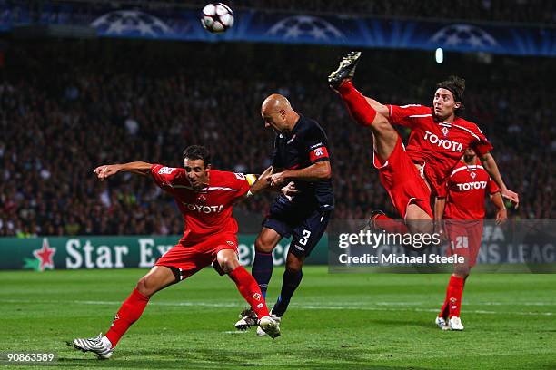 Cris of Lyon is under pressure from Dario Dainelli and Riccardo Montolivo during the UEFA Champions League Group E match between Lyon and Fiorentina...