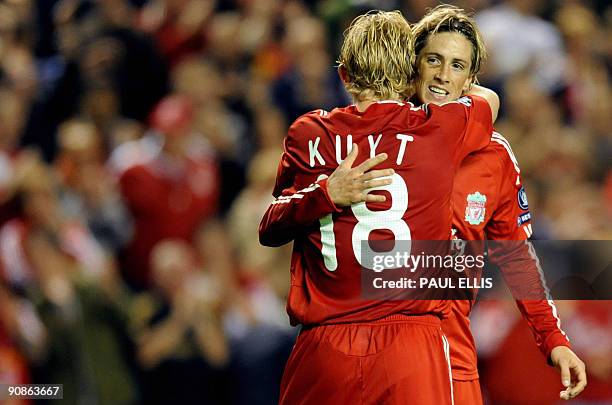 Liverpool's Spanish forward Fernando Torres congratulates Dutch forward Dirk Kuyt as he celebrates scoring against Debrecen during their UEFA...