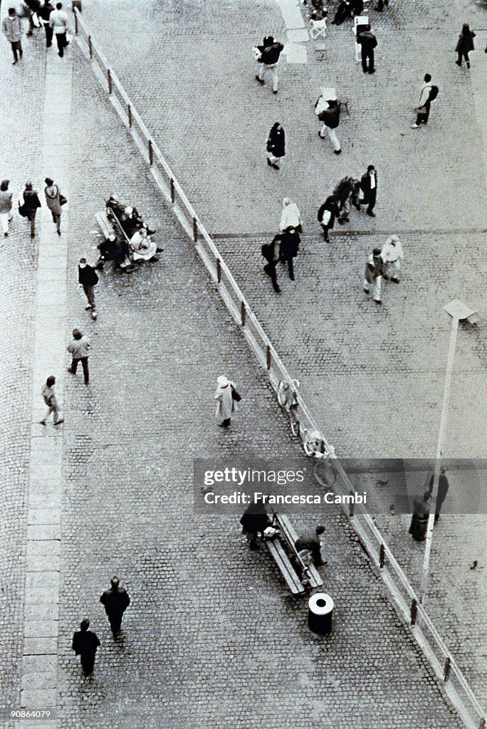 Aerial view of people walking on a cobblestone walkway