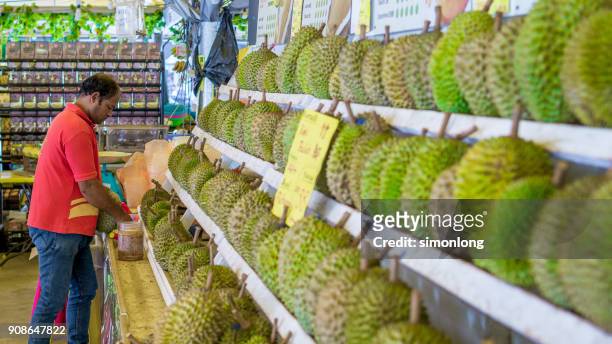 a man in front the durians stall. - famous food programa de televisión fotografías e imágenes de stock