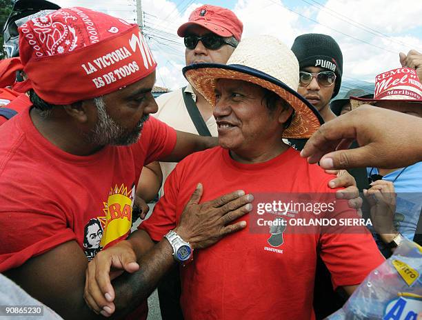 Father Jose Andres Tamallo is greeted by sympathizers during a march demanding the restitution of deposed Honduran President Manuel Zelaya on...