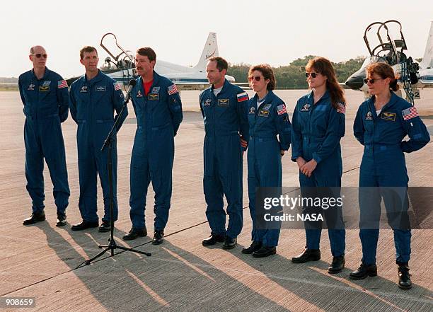 After arriving at Kennedy on the T-38 jet aircraft in the background April 26 the STS-96 crew take a few minutes to talk to the media at the Shuttle...