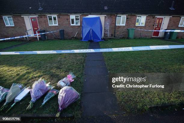 Police tent and floral tributes stand outside a home in Valley View, Brownhills, Walsall, where Mylee Billingham, aged eight, was stabbed and later...