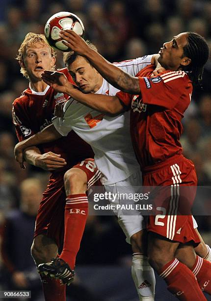 Liverpool's Dutch forward Dirk Kuyt and English defender Glen Johnson challenge Debrecen's Hungarian midfielder Peter Szakaly during their UEFA...