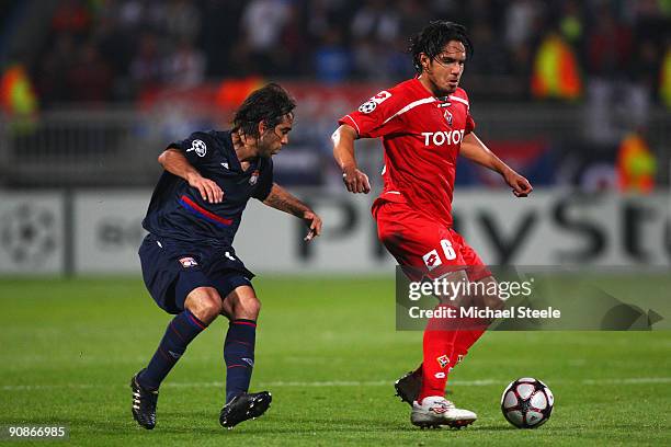 Juan Vargas of Fiorentina shields the ball from Cesar Delgado during the UEFA Champions League Group E match between Lyon and Fiorentina at the Stade...