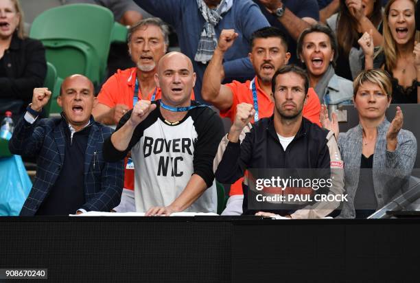 Coaches Andre Agassi and Radek Stepanek cheer on Serbia's Novak Djokovic during their men's singles fourth round match against South Korea's Hyeon...