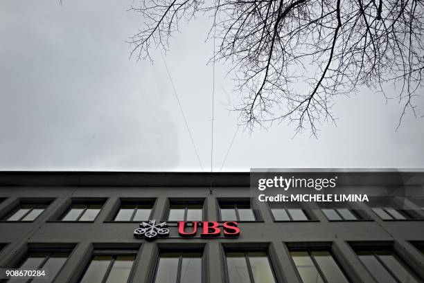 Photo taken on January 22, 2018 shows the UBS logo in Zurich. - Swiss banking giant UBS reported on January 22, 2018 that its profits plummeted 63...