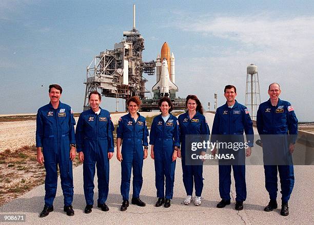 The STS-96 crew visits Launch Pad 39B April 27, 1999 where Space Shuttle Discovery, in the background, is being prepared for the mission launch on...