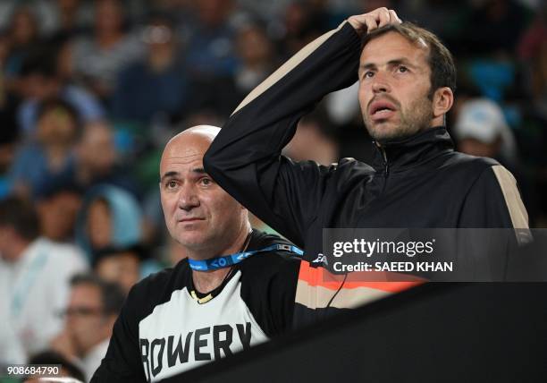 Coaches Radek Stepanek and Andre Agassi react as they watch Serbia's Novak Djokovic play South Korea's Hyeon Chung during their men's singles fourth...