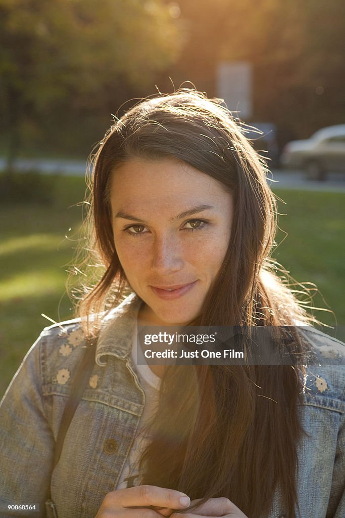 Young woman smiles in the sunset