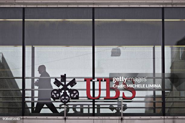 Photo taken on January 22, 2018 shows the UBS logo in Zurich. - Swiss banking giant UBS reported on January 22, 2018 that its profits plummeted 63...