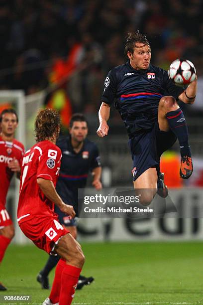 Kim Kallstrom of Lyon leaps to control the ball from Marco Donadel during the UEFA Champions League Group E match between Lyon and Fiorentina at the...