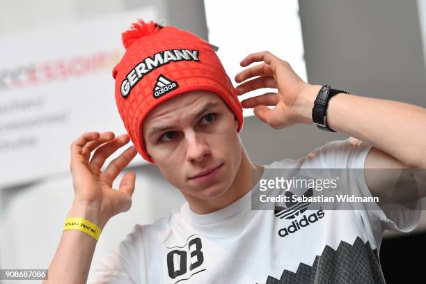 Andreas Wellinger tries on a hat during the 2018 PyeongChang Olympic Games German Team kit handover at Postpalast on January 22, 2018 in Munich,...