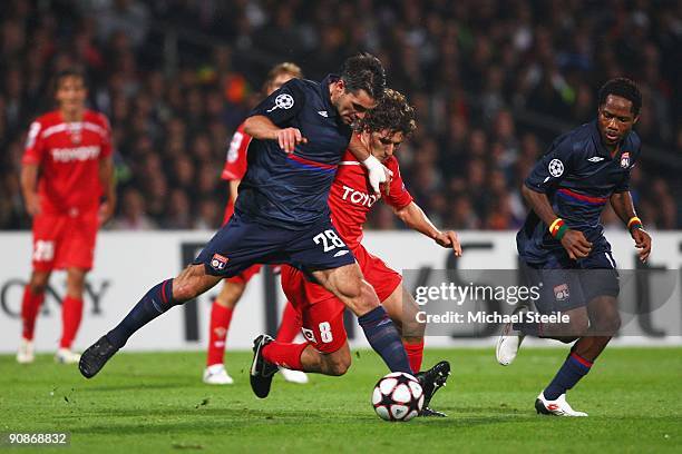 Jeremy Toulalan of Lyon holds off the challenge of Stevan Jovetic of Fiorentina during the UEFA Champions League Group E match between Lyon and...