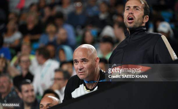 Coaches Radek Stepanek and Andre Agassi react as they watch Serbia's Novak Djokovic play South Korea's Hyeon Chung during their men's singles fourth...