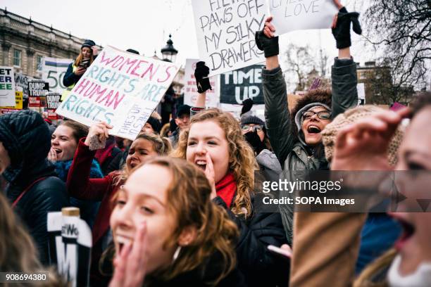 Women seen shouting slogans while holding placards and posters during the march. Scores of women across the United Kingdom took to the streets on...