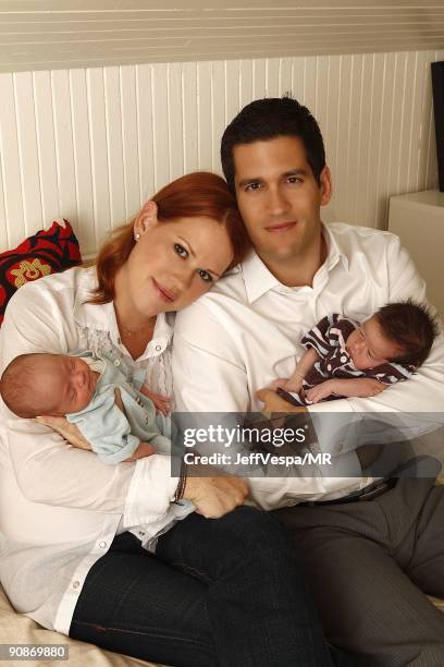 Molly Ringwald, her husband Panio Gianopoulos and their new twins Adele Georgina and Roman Stylianos pose during a photo shoot on July 29, 2009 in...