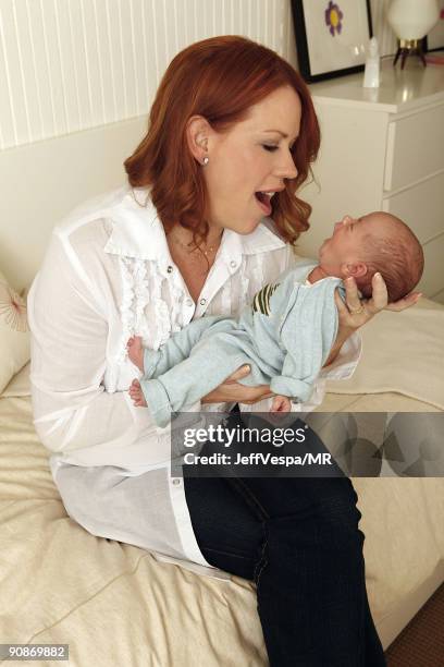 Molly Ringwald poses during a photo shoot with her newborn son Roman Stylianos on July 29, 2009 in Los Angeles, California.